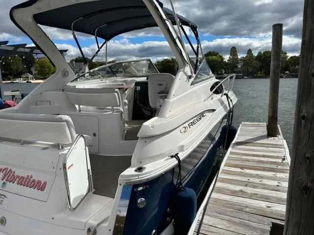 Slide: The Image of 2010 Regal 3060 Window Express boat docked by a pier. - 3