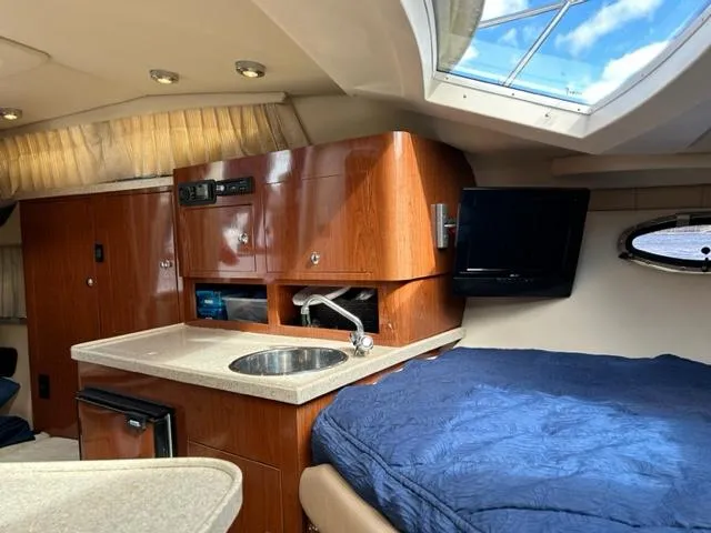 Slide: The Image of Interior of 2010 Regal 3060 Window Express boat with kitchenette and bed. - 34