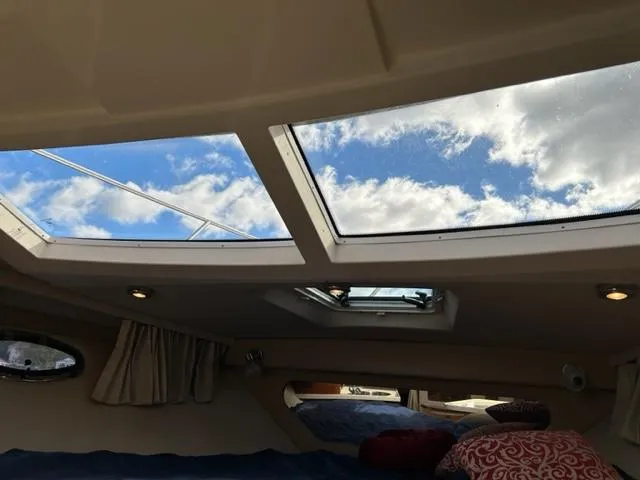 Slide: The Image of Interior cabin view of 2010 Regal 3060 Window Express with skylights and blue sky. - 35
