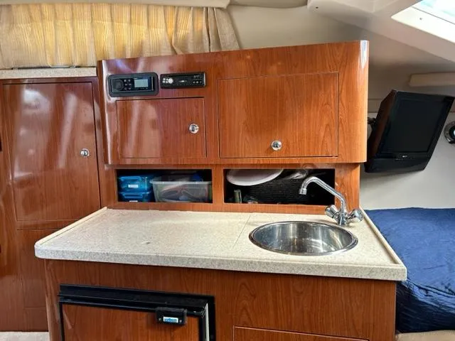Slide: The Image of 2010 Regal 3060 Window Express boat interior with kitchenette and sink. - 38