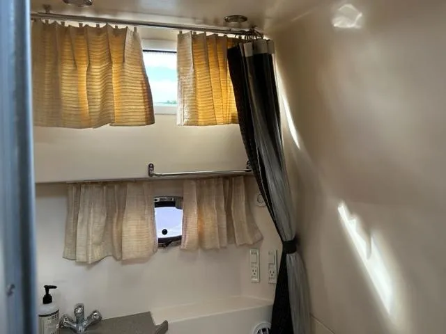 Slide: The Image of 2010 Regal 3060 Window Express bathroom with curtains and sink. - 44