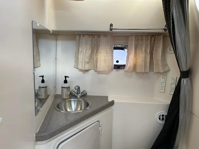 Slide: The Image of 2010 Regal 3060 Window Express bathroom with sink, mirror, and small window. - 45