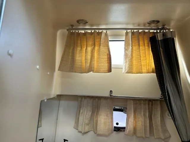 Slide: The Image of Interior of 2010 Regal 3060 Window Express with beige curtains and small windows. - 46