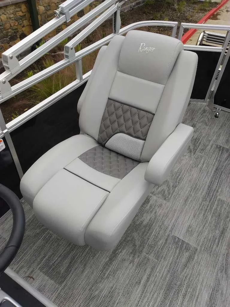 Slide: The Image of 2024 Ranger Reata 223C boat seat with gray upholstery and diamond stitching. - 17