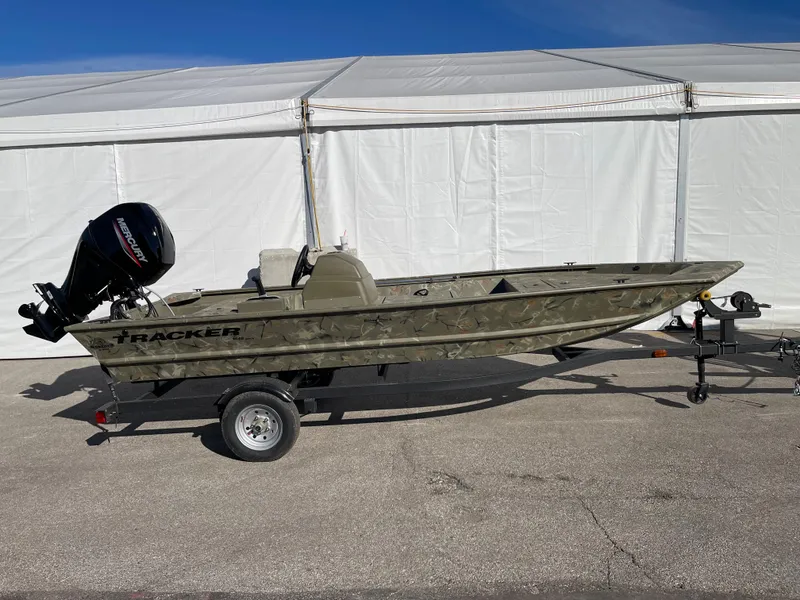 Slide: The Image of 2024 Tracker Grizzly 1648 SC boat with outboard motor on trailer. - 2