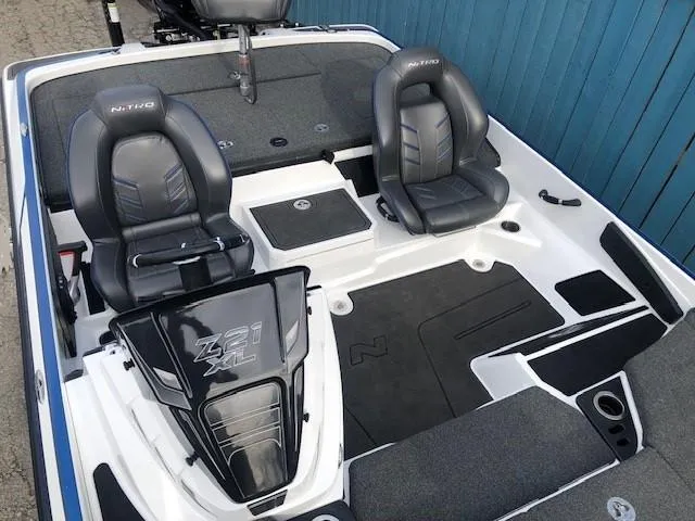 Slide: The Image of 2022 Nitro Z21 XL boat interior with dual seats and storage compartments. - 24