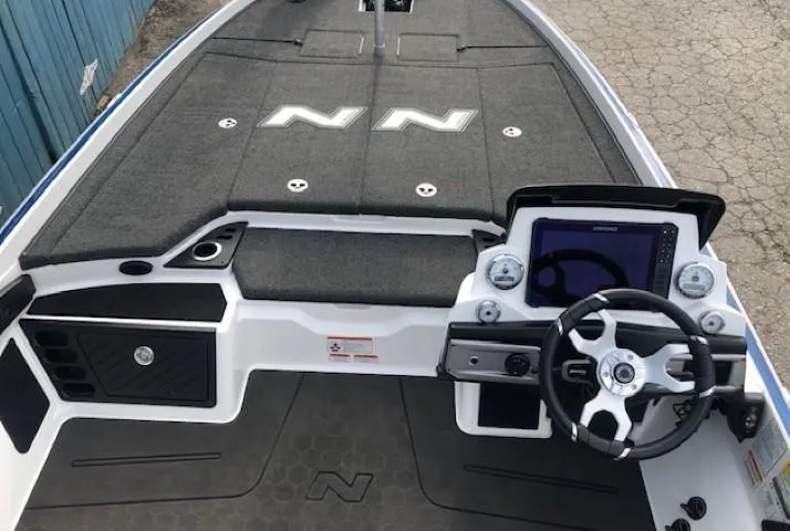 Slide: The Image of 2022 Nitro Z21 XL boat interior with steering console and spacious deck. - 25