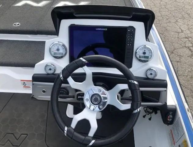 Slide: The Image of 2022 Nitro Z21 XL boat dashboard with steering wheel and Lowrance display. - 26