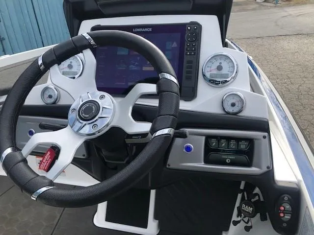 Slide: The Image of 2022 Nitro Z21 XL boat dashboard with steering wheel, gauges, and Lowrance display. - 29