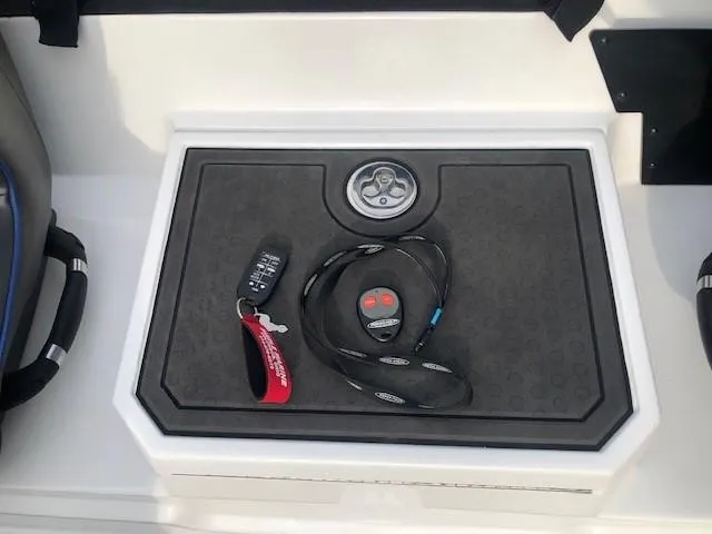 Slide: The Image of 2022 Nitro Z21 XL boat console with key fob and remote control. - 35