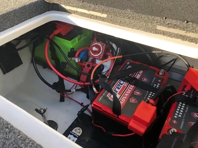 Slide: The Image of 2022 Nitro Z21 XL boat battery compartment with wiring and battery setup. - 44