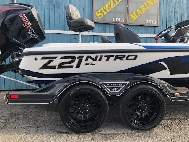 Slide: The Image of 2022 Nitro Z21 XL boat on trailer with black wheels. - 5