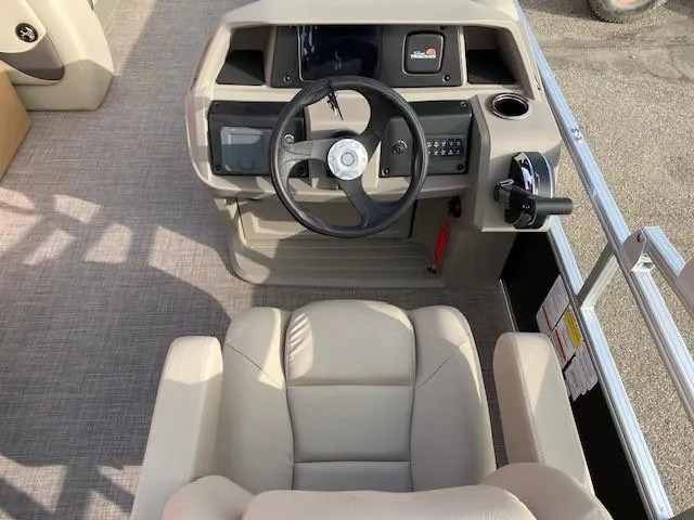 Slide: The Image of 2024 Sun Tracker Party Barge 18 DLX helm with steering wheel and captain's chair. - 10