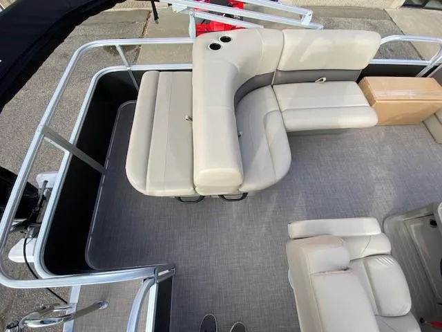 Slide: The Image of 2024 Sun Tracker Party Barge 18 DLX interior seating area with beige upholstery. - 11