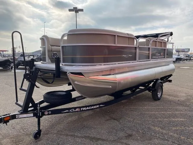 Slide: The Image of 2024 Sun Tracker Party Barge 18 DLX pontoon boat on a trailer. - 4
