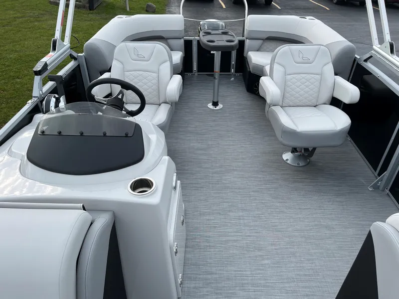 Slide: The Image of 2024 Lowe SS 210 WT pontoon boat interior with plush seating and modern helm. - 10
