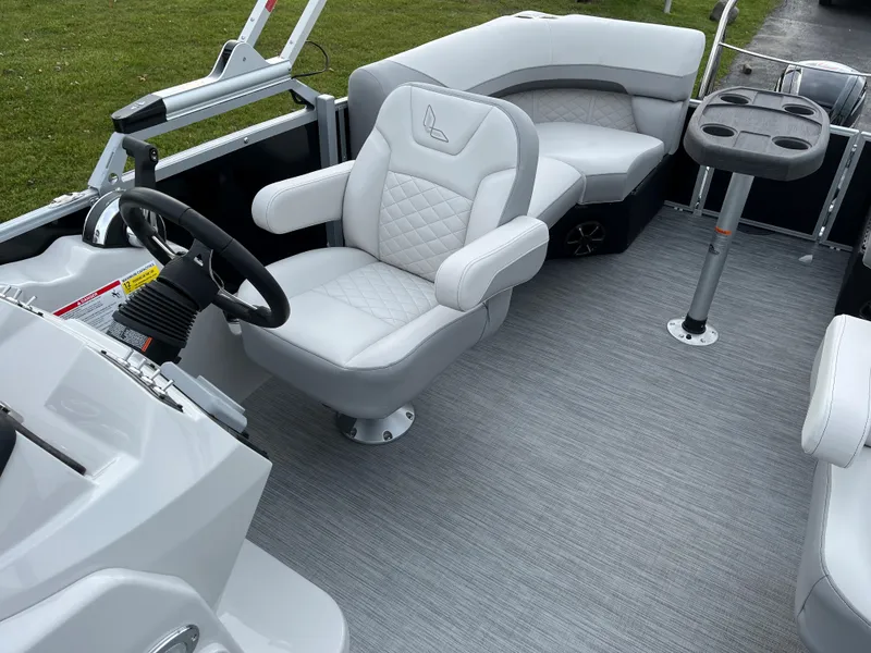 Slide: The Image of 2024 Lowe SS 210 WT boat interior with plush seating and modern helm. - 11