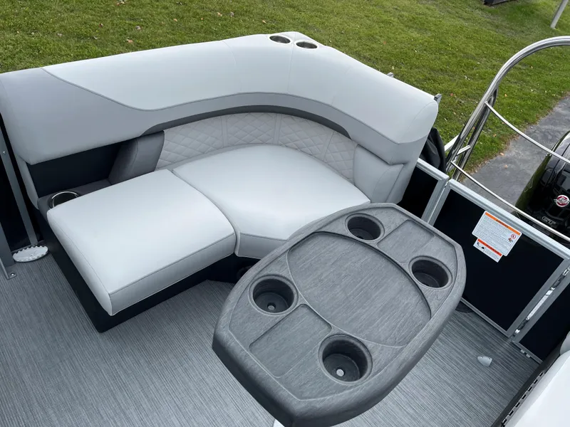 Slide: The Image of 2024 Lowe SS 210 WT boat interior with seating and table. - 13