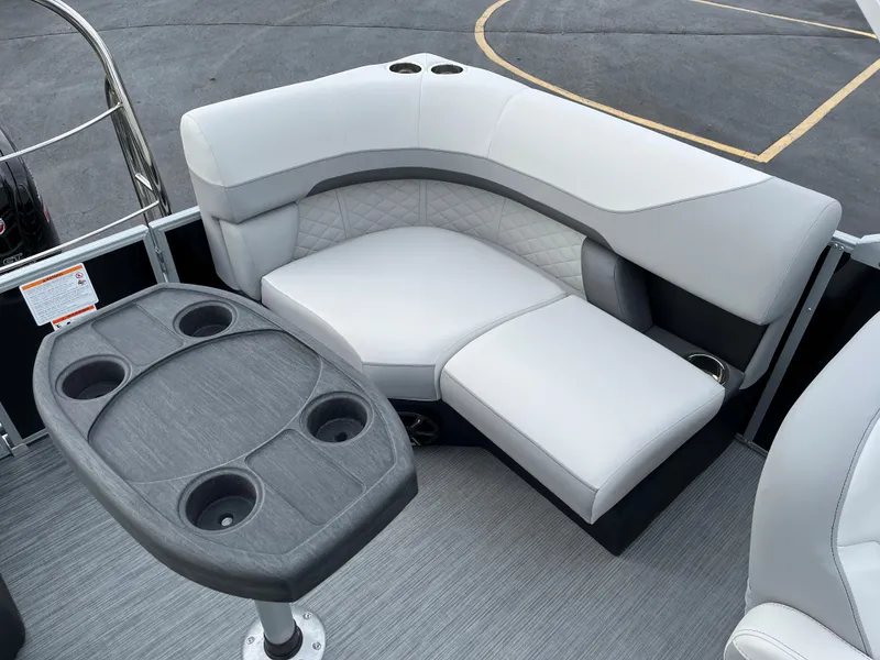Slide: The Image of 2024 Lowe SS 210 WT boat interior with cushioned seating and table. - 14