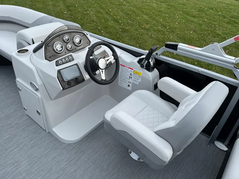 Slide: The Image of 2024 Lowe SS 210 WT boat helm with steering wheel and captain's chair. - 15