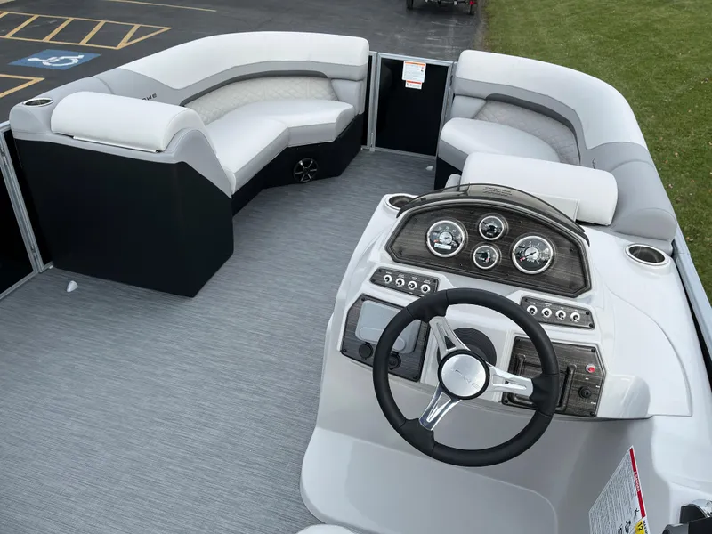 Slide: The Image of 2024 Lowe SS 210 WT pontoon boat interior with helm and seating. - 16