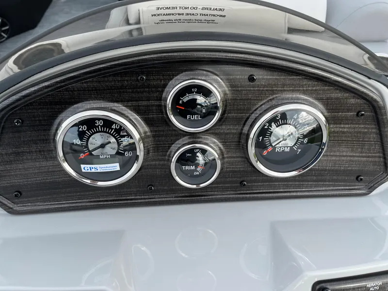 Slide: The Image of 2024 Lowe SS 210 WT boat dashboard with speedometer, fuel gauge, trim gauge, and RPM gauge. - 17