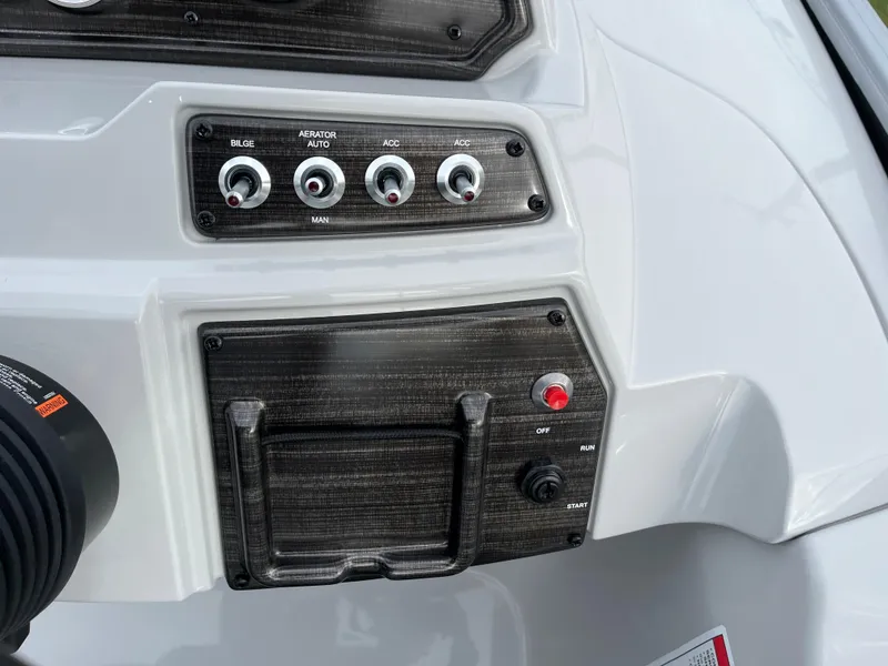 Slide: The Image of Control panel of 2024 Lowe SS 210 WT boat with switches and ignition. - 19
