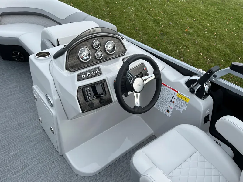 Slide: The Image of 2024 Lowe SS 210 WT boat helm with modern controls and comfortable seating. - 20