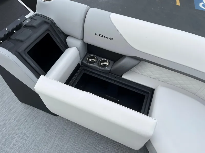 Slide: The Image of 2024 Lowe SS 210 WT boat interior with storage compartments and cup holders. - 24