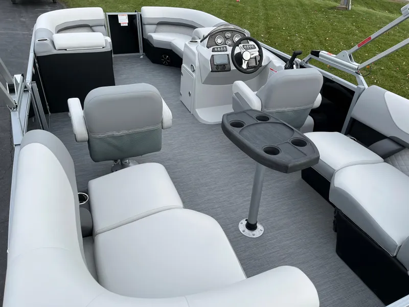 Slide: The Image of 2024 Lowe SS 210 WT pontoon boat interior with gray seating and steering console. - 7