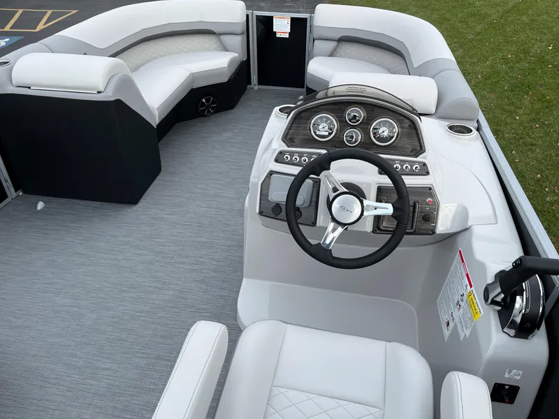 Slide: The Image of 2024 Lowe SS 210 WT pontoon boat interior with steering console and seating. - 8