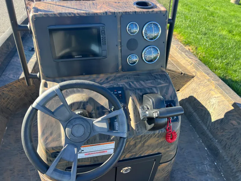 Slide: The Image of 2021 G3 Bay 20 DLX boat console with steering wheel, gauges, and Garmin display. - 11
