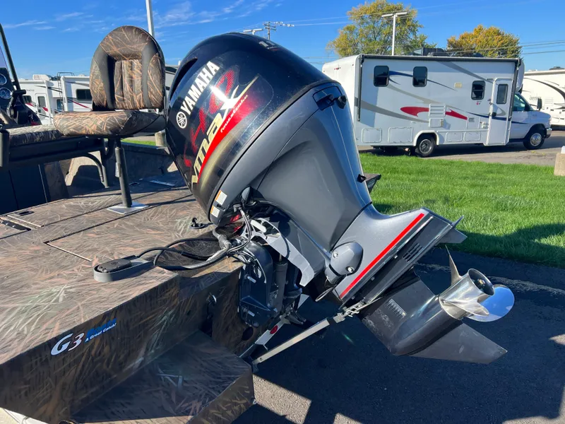 Slide: The Image of 2021 G3 Bay 20 DLX boat with Yamaha outboard motor in a parking lot. - 4