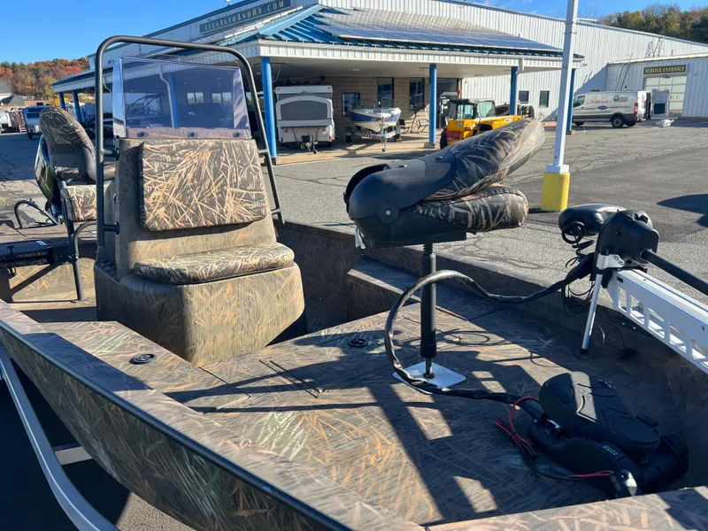 Slide: The Image of 2021 G3 Bay 20 DLX boat with camo seats and console, parked at a dealership. - 9