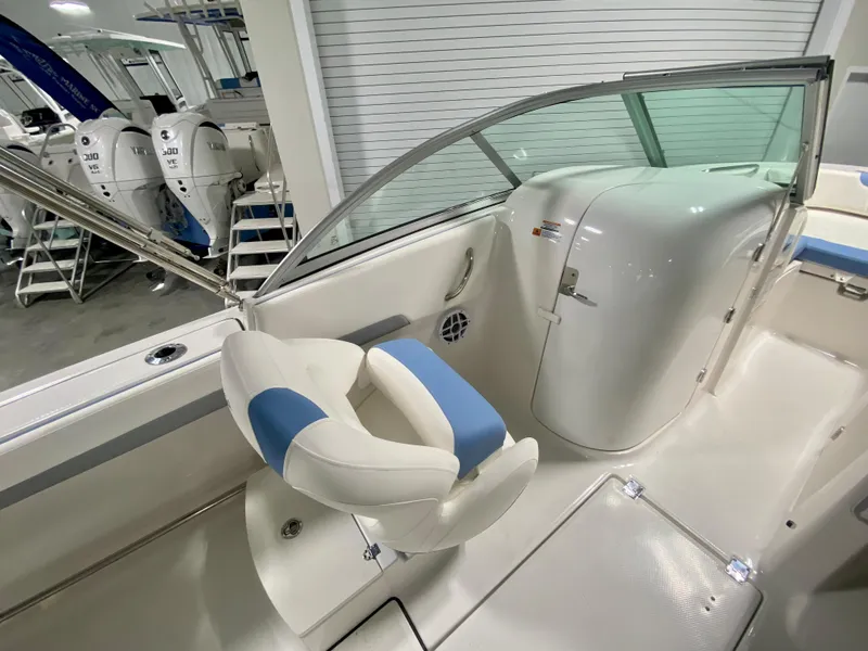 Slide: The Image of 2024 Robalo R207 Dual Console boat interior with white and blue seating. - 10