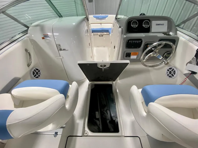 Slide: The Image of 2024 Robalo R207 Dual Console boat interior with open storage compartment and dual seating. - 11