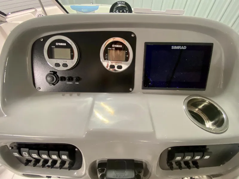 Slide: The Image of 2024 Robalo R207 Dual Console dashboard with Yamaha gauges and Simrad display. - 14