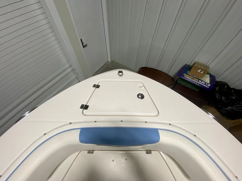 Slide: The Image of 2024 Robalo R207 Dual Console boat bow storage compartment. - 24
