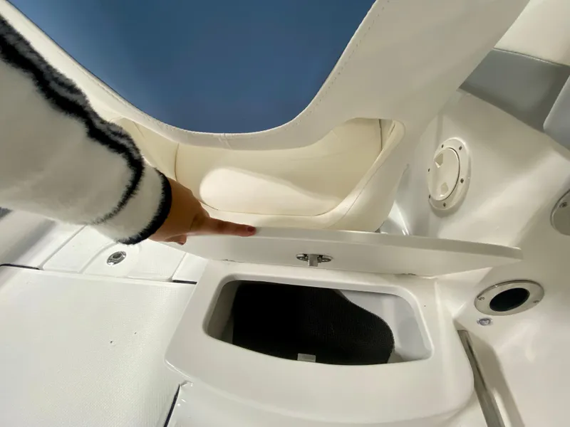 Slide: The Image of 2024 Robalo R207 Dual Console storage compartment under seat. - 7