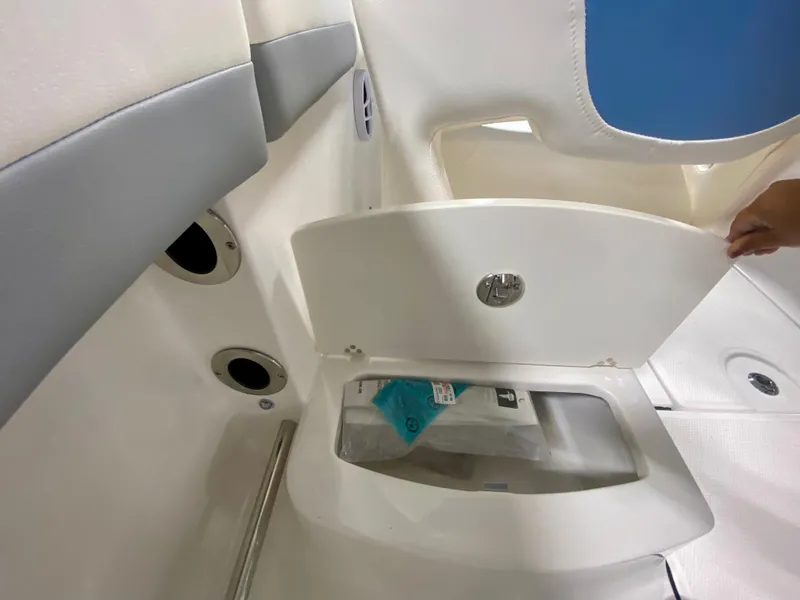 Slide: The Image of 2024 Robalo R207 Dual Console storage compartment with open hatch. - 8