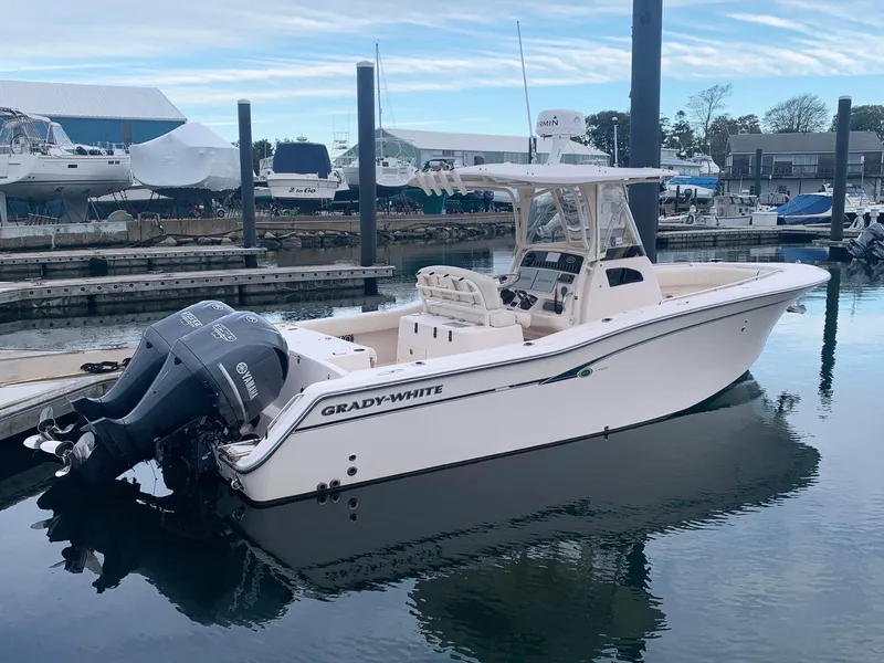 Slide: The Image of 2013 Grady-White Canyon 271 boat docked in a marina. - 0