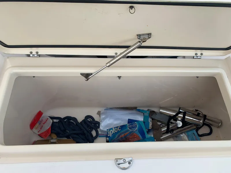 Slide: The Image of Storage compartment of a 2013 Grady-White Canyon 271 boat with various items. - 10