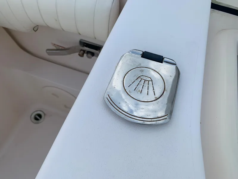 Slide: The Image of 2013 Grady-White Canyon 271 boat deck with a metal shower button. - 11