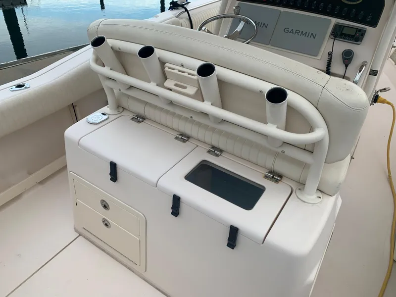 Slide: The Image of 2013 Grady-White Canyon 271 boat interior with rod holders and storage compartments. - 12