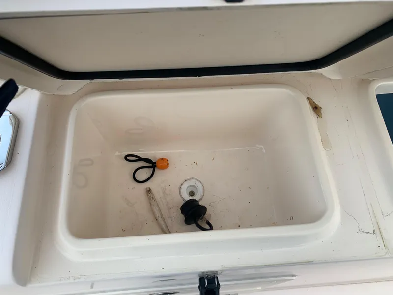 Slide: The Image of Open storage compartment on a 2013 Grady-White Canyon 271 boat. - 14