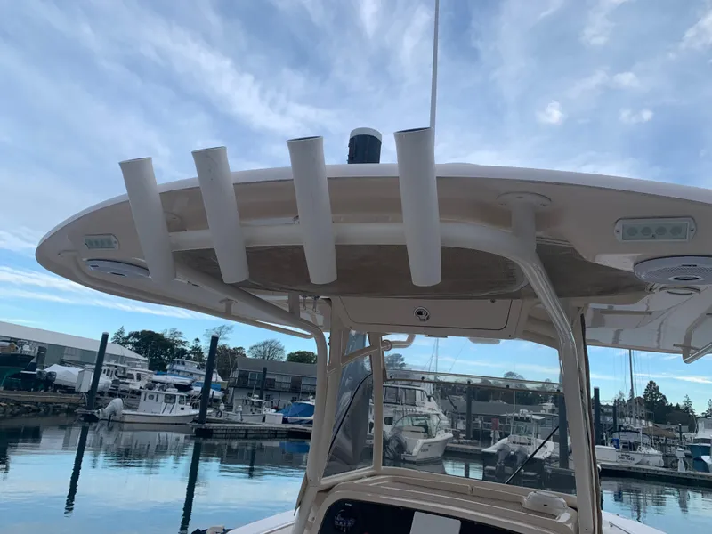 Slide: The Image of 2013 Grady-White Canyon 271 boat at marina, rod holders visible. - 16