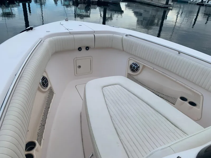 Slide: The Image of 2013 Grady-White Canyon 271 boat interior with white cushioned seating. - 18