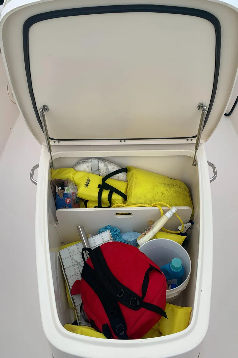 Slide: The Image of Storage compartment of a 2013 Grady-White Canyon 271 boat with safety gear. - 20