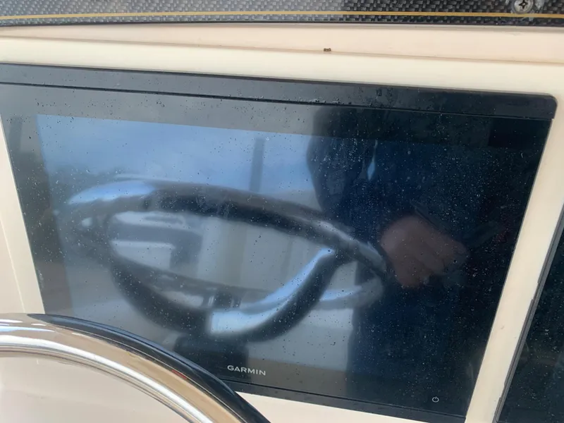 Slide: The Image of Garmin display and steering wheel on 2013 Grady-White Canyon 271 boat. - 24