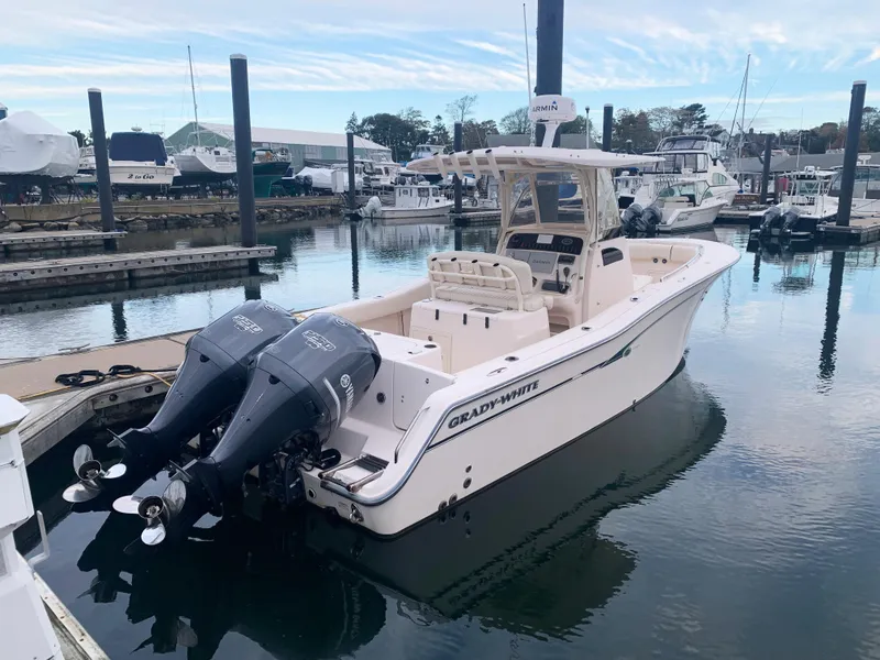 Slide: The Image of 2013 Grady-White Canyon 271 boat docked with twin outboard engines. - 3